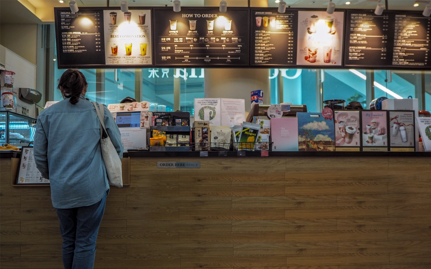 hero image of a woman purchasing bubble tea or boba tea from a bubble tea store