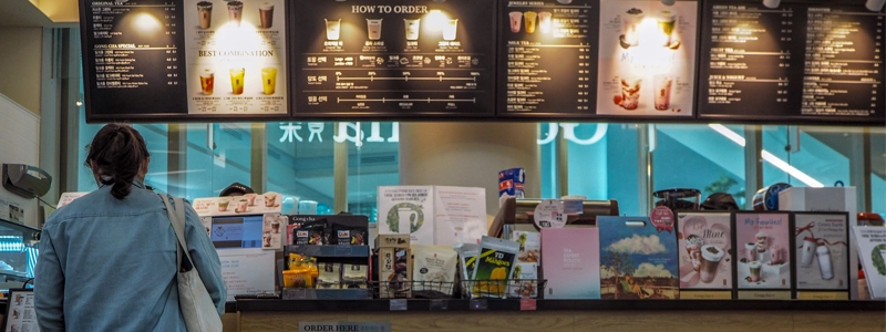 Flysoft POS machine and customer display are showcased in front of Bubble Tea store.